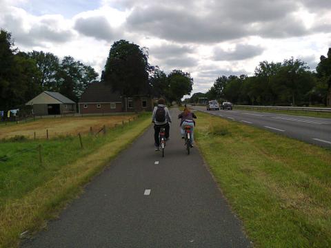 Dutch teenagers riding alongside a main road