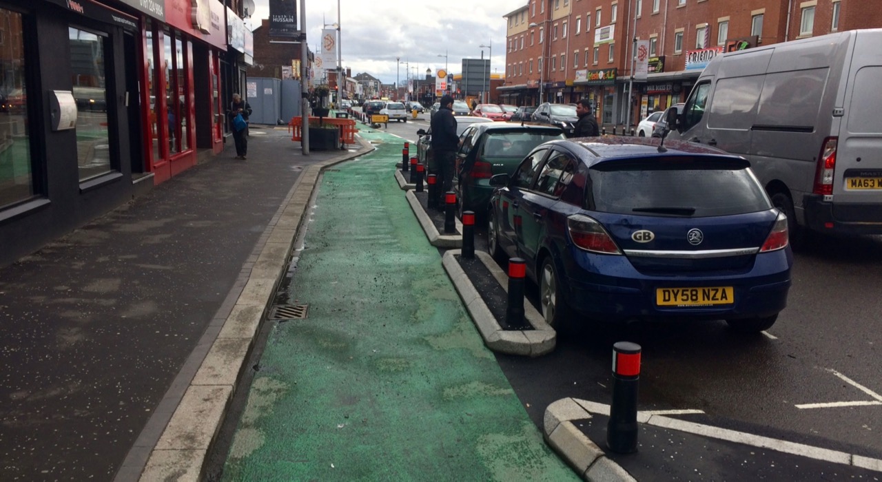 A cycle lane protected by car parking spaces