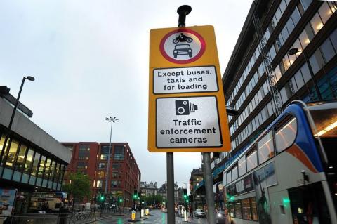 Signs notifying drivers of enforcement cameras for a bus lane.