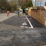 Giveway lines on a cycle lane on the pavement.