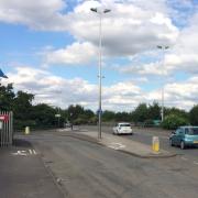 Cycle route crossing entrance to industrial site.