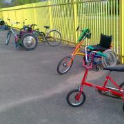 A selection of adapted cycles, with a Raleigh Chopper style tricycle in the foreground