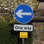 One way sign on a British street.