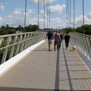 A family and their dog crossing Diglis Bridge