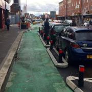 A cycle lane protected by car parking spaces