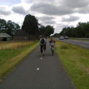 Dutch teenagers riding alongside a main road