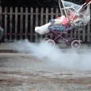 Image from Greenpeace of baby in pushchair next to exhaust fumes.