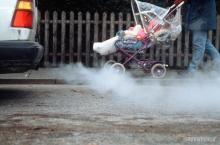 Image from Greenpeace of baby in pushchair next to exhaust fumes.